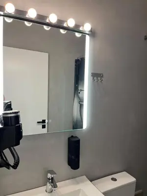 a bathroom with a large mirror and a sink at Fos Diamond Suite by Zeus Suites in Athens