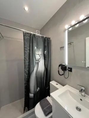 a bathroom with a black and white cat shower curtain at Tsakalof 17 Jacuzzi Kolonaki Suite by Zeus Suites in Athens