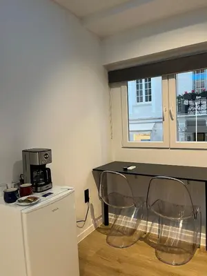 a kitchen with a table and two chairs in a room at Tsakalof 17 Jacuzzi Kolonaki Suite by Zeus Suites in Athens