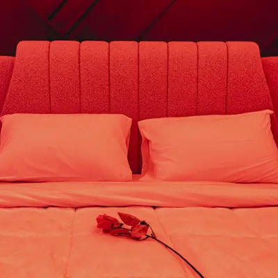 a bed with a red headboard with a rose on it at Tsakalof 17 Jacuzzi Kolonaki Suite by Zeus Suites in Athens