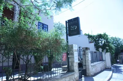a sign on the side of a building at Nanny's Guest House in Plaka in Athens