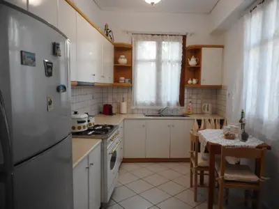 a kitchen with a refrigerator and a table in it at Nanny's Guest House in Plaka in Athens