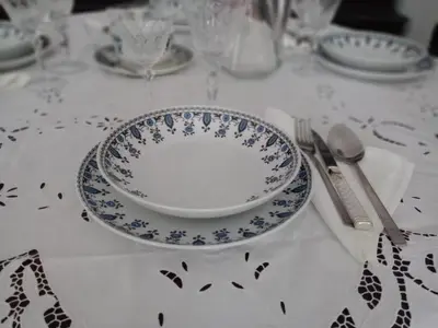 a table with a blue and white plate and fork and knife at Nanny's Guest House in Plaka in Athens