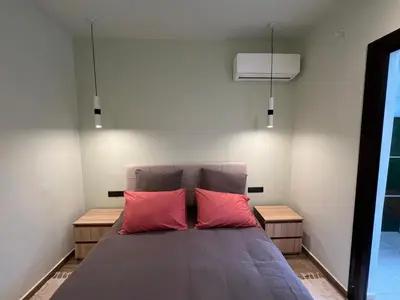 a bedroom with a bed with two red pillows at Modern apartment with patio in Athens