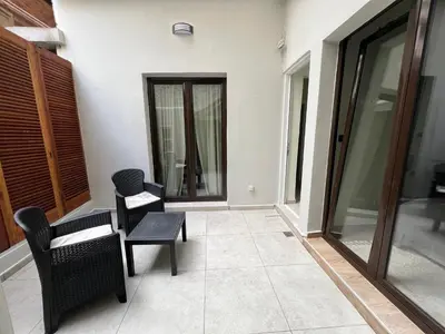 a living room with two chairs and a table at Modern apartment with patio in Athens