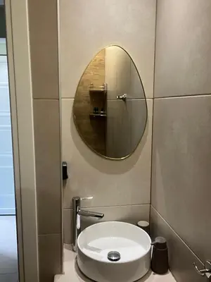 a bathroom with a white sink and a mirror at Modern apartment with patio in Athens