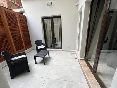 a living room with two chairs and a table at Modern apartment with patio in Athens