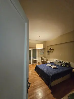 a bedroom with a bed and a living room at Kolonaki hug in Athens