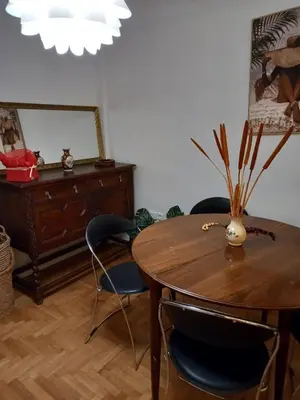 a dining room with a wooden table and chairs at Kolonaki hug in Athens