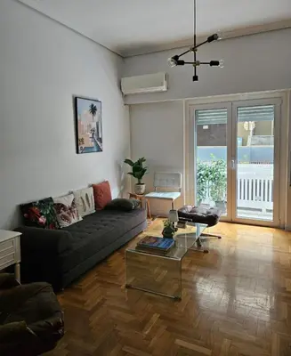 a living room with a couch and a table at Kolonaki hug in Athens