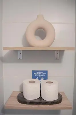 two rolls of toilet paper sitting on a shelf at Studio in trendy Pagkrati district in Athens
