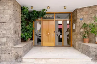 an entrance to a building with a yellow door at Studio in trendy Pagkrati district in Athens