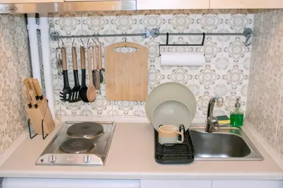 a kitchen counter with a sink and a stove at Studio in trendy Pagkrati district in Athens