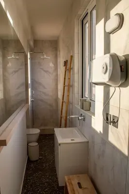a small bathroom with a toilet and a sink at Studio with Acropolis View at Platia Avdi in Athens