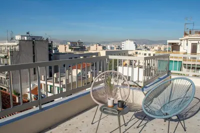 two chairs and a table on a balcony at Studio with Acropolis View at Platia Avdi in Athens