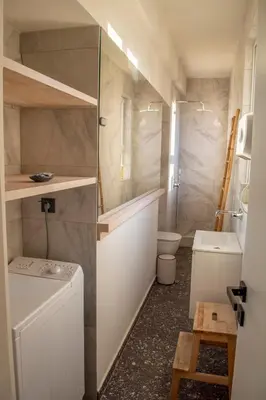 a small bathroom with a toilet and a sink at Studio with Acropolis View at Platia Avdi in Athens