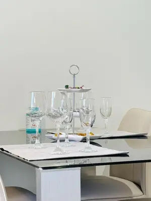 a table with wine glasses on top of it at Palio Faliro Beach Luxury Apartments in Athens