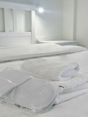 two towels sitting on top of a bed at Palio Faliro Beach Luxury Apartments in Athens