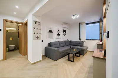 a living room with a couch and a table at Panos City Apartment - Private parking for motorcycles in Athens