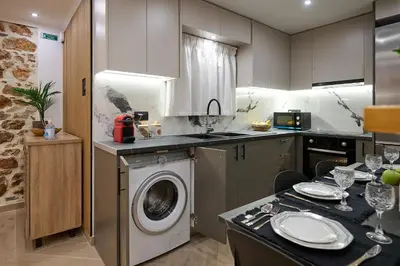 a kitchen with a washing machine in a kitchen at Panos City Apartment - Private parking for motorcycles in Athens