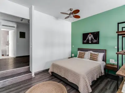 a bedroom with a bed and a ceiling fan at Central Hideaway Near Ermou Street Perfect For Groups And Families in Athens