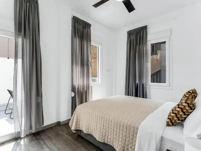 a white bedroom with a bed and a window at Central Hideaway Near Ermou Street Perfect For Groups And Families in Athens