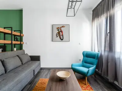 a living room with a couch and a blue chair at Central Hideaway Near Ermou Street Perfect For Groups And Families in Athens