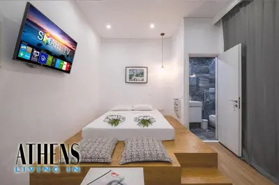 a bedroom with a bed and a tv on the wall at Classic Studio A2 - 2ppl in Athens