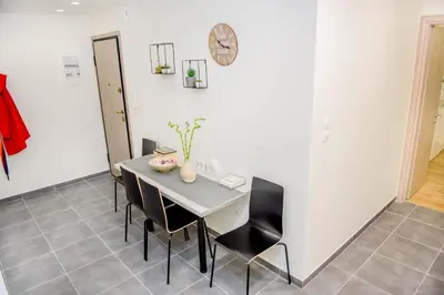 a dining room with a table and chairs at Athenian Hideaway - Spa Tub and Walk to Metro in Athens