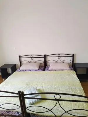 a bedroom with a bed with purple pillows at Berry room 4 in Athens