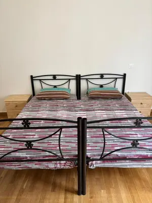 a bed with a colorful blanket on top of it at Berry room 4 in Athens