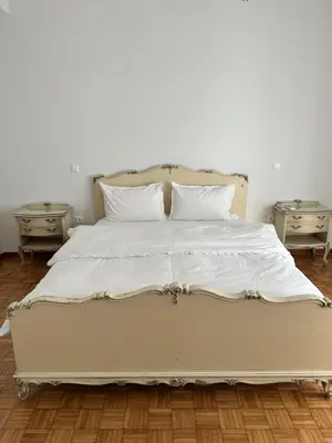 a large white bed with two nightstands and two tables at Graffiti One Studio in Athens