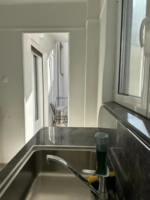 a kitchen counter with a sink and a mirror at Graffiti One Studio in Athens