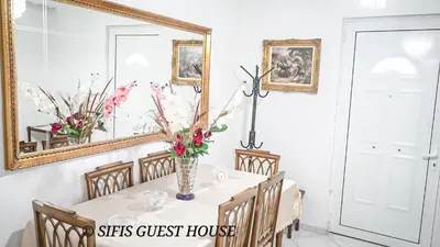 a dining room with a table and a mirror at Sifis home in Athens