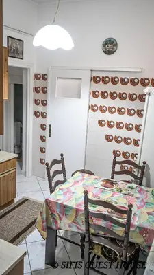 a kitchen with a table and a wall with plates at Sifis home in Athens