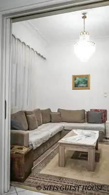 a living room with a couch and a table at Sifis home in Athens