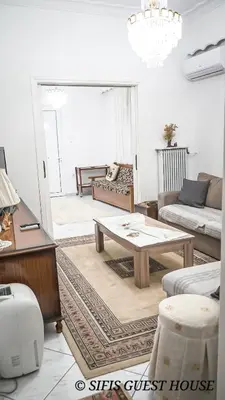 a living room with a coffee table and a couch at Sifis home in Athens