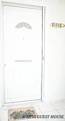 a door with a sign that reads sisters guest house at Sifis home in Athens