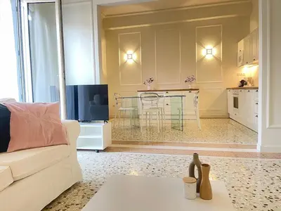 a living room with a white couch and a table at White Gem of Piraeus in Piraeus