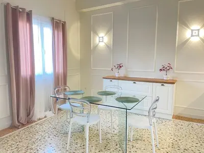 a dining room with a glass table and chairs at White Gem of Piraeus in Piraeus