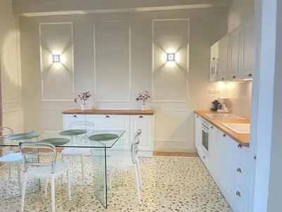 a kitchen with a glass table and chairs at White Gem of Piraeus in Piraeus