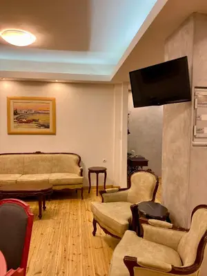 a living room with couches and a flat screen tv at Athens Acropolis Living in Athens