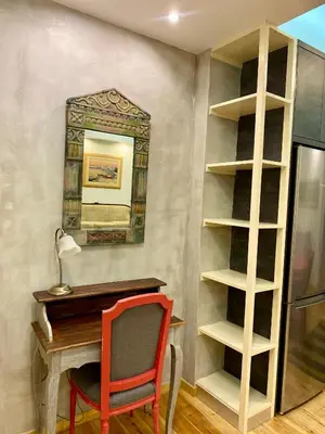 a desk and a chair in a room with a shelf at Athens Acropolis Living in Athens