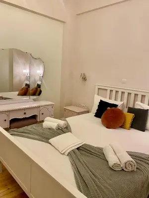 two beds in a bedroom with a large mirror at Athens Acropolis Living in Athens