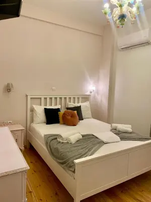 a bedroom with a large white bed with pillows at Athens Acropolis Living in Athens