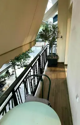 a room with a table and a balcony with trees at Athens Acropolis Living in Athens
