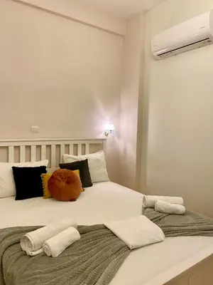 a bedroom with a large white bed with pillows at Athens Acropolis Living in Athens