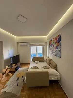 a living room with a bed and a couch at AtticNest in Athens