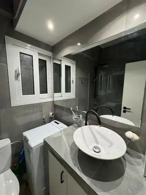 a bathroom with a sink and a toilet at AtticNest in Athens