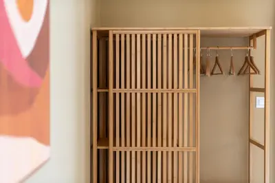 a wooden book shelf in a room at Frederic - 2BR in the Historic Center in Athens